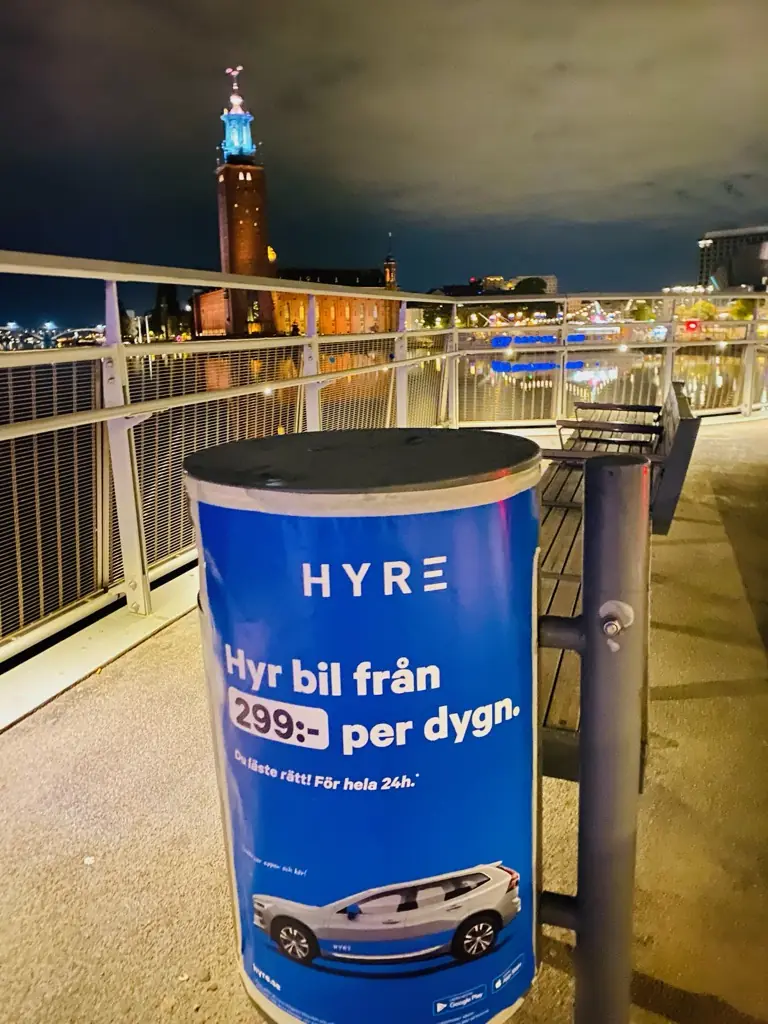 HYRE-affisch på en pelare med Stadshuset i bakgrunden