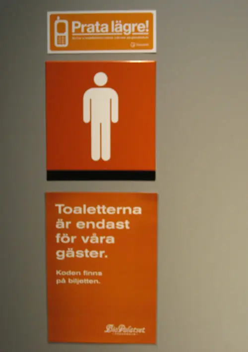 Talk quieter sign on a toilet door at Biopalatset